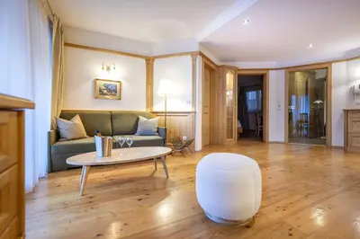 a living room with a couch and a table at Marienstern Apartments in Santa Cristina in Val Gardena