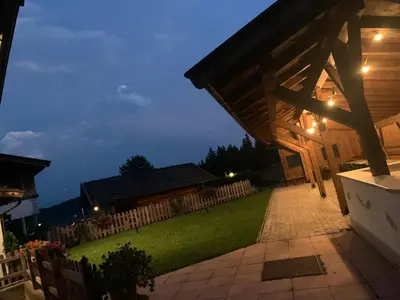 a backyard with a wooden fence and a house at Grunen Baum - Vöran in Verano