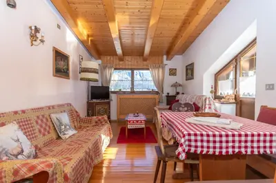 a living room with two beds and a couch at Casa Paola in Rocca Pietore