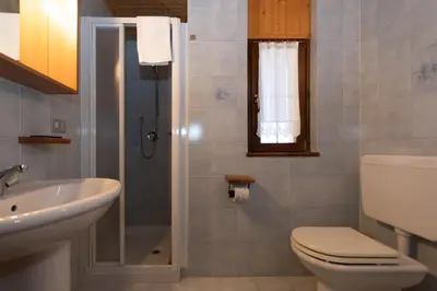 a bathroom with a toilet and a sink at Casa Paola in Rocca Pietore