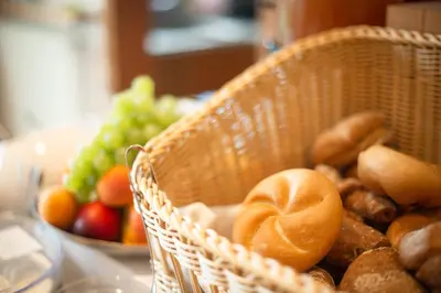 a basket filled with bread and vegetables on a table at Haselgrund in Tirolo