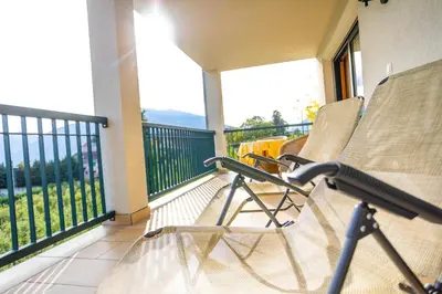 a balcony with two chairs on a balcony at Haselgrund in Tirolo
