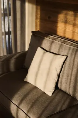 a pillow sitting on top of a couch at Les Pares in Corvara in Badia