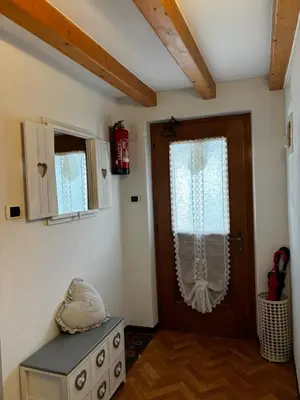 a room with a stove and a door with a window at Appartamento Ika in Canazei