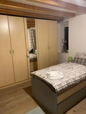 a bedroom with a bed and some cupboards at Appartamento Ika in Canazei