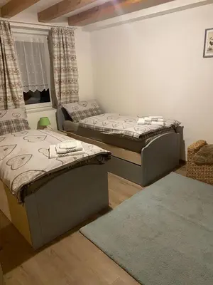 a room with two beds and a window at Appartamento Ika in Canazei