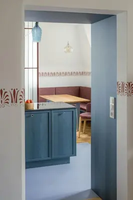 a kitchen with blue cabinets and a table at Steinach10 in Merano