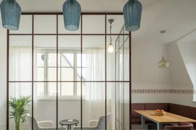 a room with a table and chairs and a window at Steinach10 in Merano
