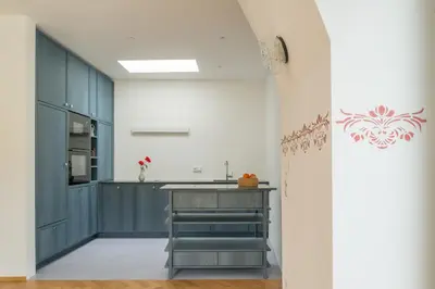 a kitchen with blue cabinets and a counter at Steinach10 in Merano