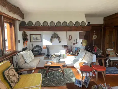 a living room with couches and chairs and a table at Appartamento La Montanella in Cortina dʼAmpezzo