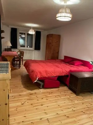 a bedroom with a large red bed and a table at Monoloclae-Prati di Solaiolo in Solaiolo