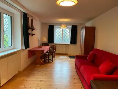 a living room with a red couch and a table at Monoloclae-Prati di Solaiolo in Solaiolo