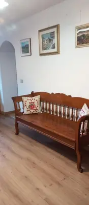 a wooden bench with two pillows on it in a room at Lili's house in Pera