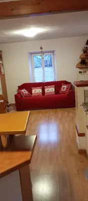 a living room with a red couch in a room at Lili's house in Pera
