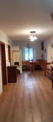 an empty living room with wooden floors and a table at Lili's house in Pera