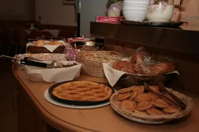 a table with bread and other food on it at Garni Eden in Canazei