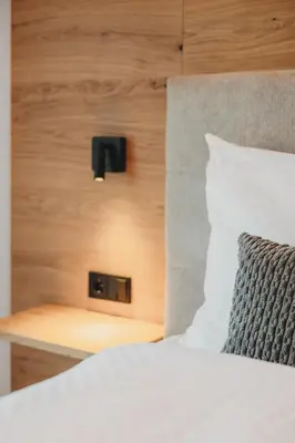 a close up of a bed with a pillow and a lightswitch at Stein unter Lebenberg NEW 2026 in Cermes
