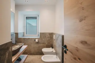a bathroom with a sink and a toilet and a window at Stein unter Lebenberg NEW 2026 in Cermes