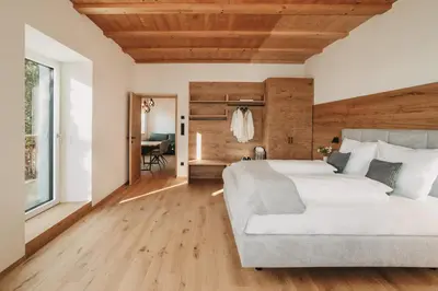 a bedroom with a large bed and a couch at Stein unter Lebenberg NEW 2026 in Cermes