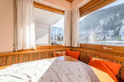 a bedroom with a bed and a large window at Appartamento Bernardi in Caprile