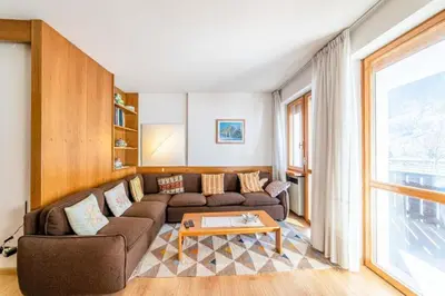 a living room with a couch and a table at Appartamento Bernardi in Caprile
