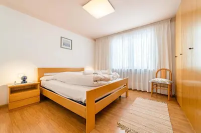 a bedroom with a bed and a window at Appartamento Bernardi in Caprile