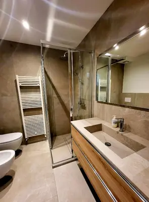 a bathroom with a sink and a toilet and a mirror at Casa Diletta in Prade