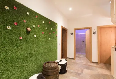 a room with a green wall with flowers on it at Unterthurnerhof in Rifiano
