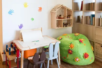 a childs room with a table and a green bean chair at Unterthurnerhof in Rifiano