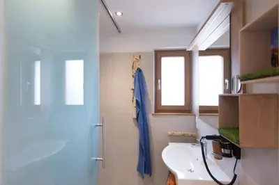 a bathroom with a sink and a window at Unterthurnerhof in Rifiano