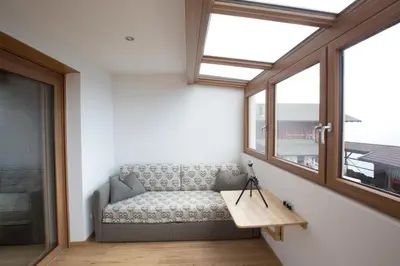 a living room with a couch and a window at Unterthurnerhof in Rifiano