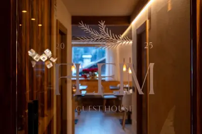 a dining room with a dining table and a guest house at Guest House Fleim in Panchia