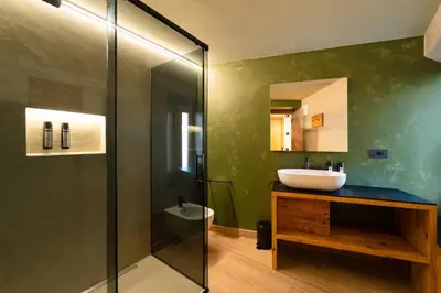 a bathroom with a sink and a shower at Guest House Fleim in Panchia