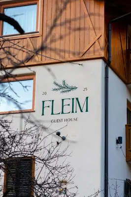a sign on the side of a guest house at Guest House Fleim in Panchia