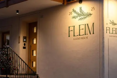 a wall of a building with a sign on it at Guest House Fleim in Panchia