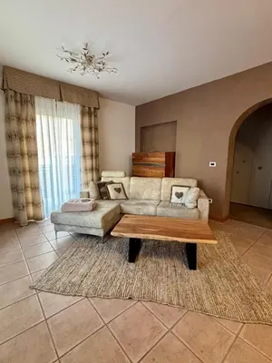 a living room with a couch and a coffee table at Villa Serena - appartamento a Fiera di Primiero in Tonadico