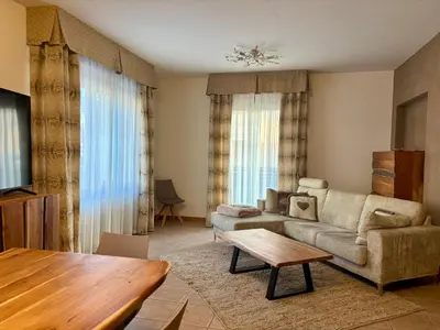 a living room with a couch and a table at Villa Serena - appartamento a Fiera di Primiero in Tonadico