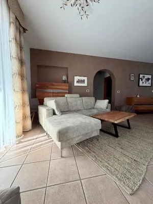 a living room with a couch and a table at Villa Serena - appartamento a Fiera di Primiero in Tonadico