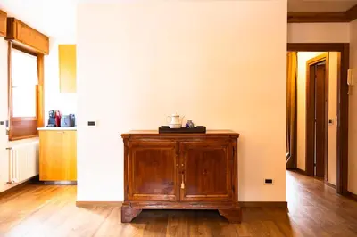 a kitchen with a wooden cabinet in a room at Comodo appartamento a San Vito di Cadore in San Vito di Cadore