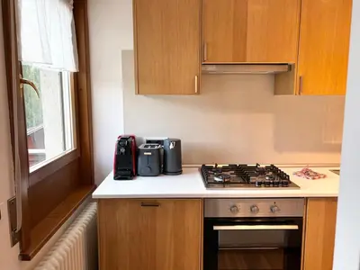 a kitchen with a stove and a counter top at Comodo appartamento a San Vito di Cadore in San Vito di Cadore
