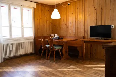 a room with a desk with a computer and a television at Appartamento panoramico al 2 Piano in San Vito di Cadore