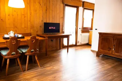 a room with a table with a laptop computer on it at Appartamento panoramico al 2 Piano in San Vito di Cadore