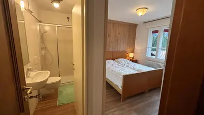 a bathroom with a bed and a sink and a toilet at Appartamento panoramico al 2 Piano in San Vito di Cadore