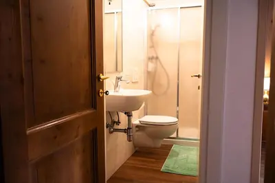 a bathroom with a toilet and a sink at Appartamento panoramico al 2 Piano in San Vito di Cadore