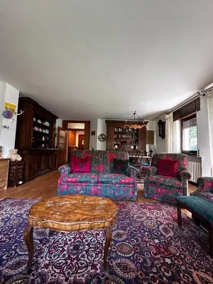 a living room with couches and a coffee table at Chalet Sofia in San Vito di Cadore