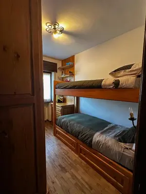 two bunk beds in a room with a hallway at Chalet Sofia in San Vito di Cadore