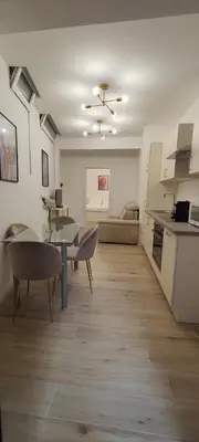 a kitchen with white cabinets and a sink and a microwave at App stay in Bolzano