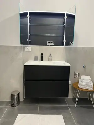 a bathroom with a sink and a mirror at App stay in Bolzano