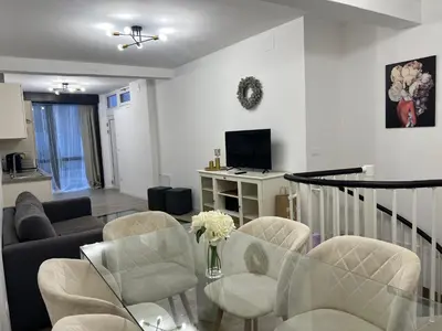 a living room with a couch and chairs and a tv at App stay in Bolzano