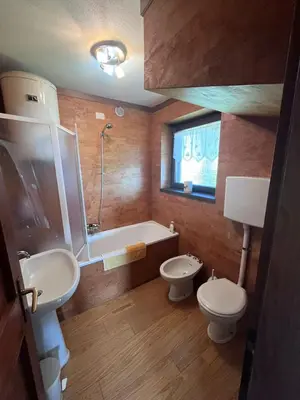 a bathroom with two sinks and a tub and a toilet at Chez Mati by Sunhome Fiemme in Cavalese